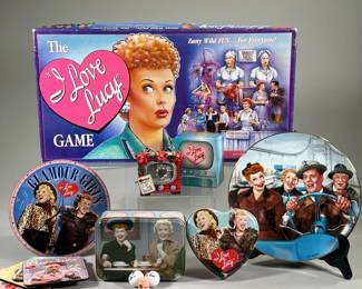 I LOVE LUCY COLLECTIBLES | Including The I Love Lucy board game, a Hamilton Collection plate, a "Glamour Girls" clock, playing cards, a collectible tin, thimble and two miniature cue balls, a miniature TV set, and a TV set gift box; plus four Lucy coasters
