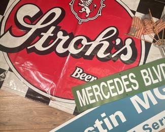 (3PC) AUTOMOTIVE SIGN LOT | Tin blue and white Austin MG sign, tin green Mercedes’ BLVD street sign, Stroh’s vinyl checkered sign. - w. 46 x h. 33 in
