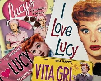 (4PC) I LOVE LUCY SIGNS & LICENSE PLATES | Two decorative metal signs and two license plates, including "VITA GRL" and "America's Favorite Redhead!" - w. 12.5 x h. 16 in (largest)
