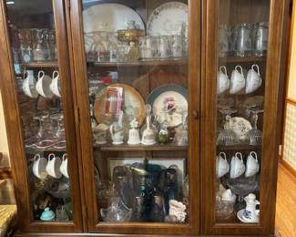 Very nice china cabinet with vintage pieces.