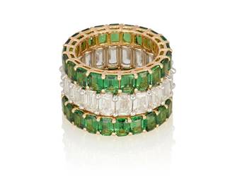 97
A Group Of Three Eternity Bands
Comprising a platinum eternity band set with 20 emerald-cut diamonds weighing 6.10 carats, and 2 18K gold bands each set with 22 tsavorite garnets weighing either 4.74 carats or 4.65 carats.

The diamond eternity band is accompanied by 20 GIA reports stating that the diamonds are all I color and range from VVS1 to VS2 clarity.
3 pieces
14.6 grams
Size: 6
Estimate: $12,000 - $18,000