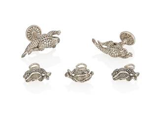4
A Sterling Silver Dress Set, Kieselstein-Cord
The set designed as a series of frogs in sterling silver, signed Kieselstein-Cord.
5 pieces
33.2 grams
Cuff links: 1 1/2" H x 1/2" W; Studs: 3/4" H x 1/4" W
Estimate: $300 - $500