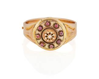 109
A Victorian Diamond, Garnet, Seed Pearl And Gold Bracelet
The hinged bracelet centering an old mine-cut diamond weighing approximately .15 carat, highlighted with seven seed pearls (one seed pearl missing), and eight circular-cut garnets weighing a total of approximately 1.60 carats, further accented with white enamel, in 14K gold.
39.30 grams
2 1/8" Dia.
Estimate: $600 - $800