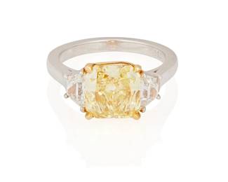 191
A Colored Diamond Ring
Centering a radiant-cut fancy, intense yellow diamond weighing 3.06 carats, accented by trapezoid-shaped diamonds on either side with a total weight of .78 carat, mounted in 18K gold and platinum.

Accompanied by GIA report number 2225780930 stating that the diamond is Fancy Intense Yellow, Natural Color, I1 clarity.
6.73 grams
Size: 6
Estimate: $25,000 - $35,000