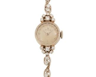 121
Lady's White Gold Watch, Rolex
Ref: L77992
Dial: White with dart and dot markers, tapered hands
Movement: 17-jewel
Case: 15 mm 14K gold round with faceted crystal
Bracelet: 14K white gold, set with round brilliant and single-cut diamonds, estimated 0.95 carat total weight foldover clasp, 6 3/4" L
16.6 grams
Estimate: $1,200 - $1,800