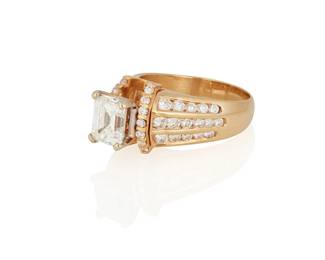 35
A Diamond Ring
Set with an emerald-cut diamond measuring 7.85 x 6.69 x 4.52 mm and weighing 2.08 carats, framed on either side with three rows of round brilliant-cut diamonds weighing a total of approximately 1.10 carats, set in 14K gold.

Accompanied by GIA report number 6224694033 stating that the emerald-cut diamond is G color, VVS2 clarity.
9.3 grams
Size: 8.5
Estimate: $15,000 - $20,000