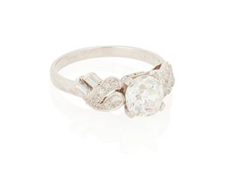 41
A Diamond And Gold Ring
Centering an old European-cut diamond measuring 7.39 mm x 7.85mm x 4.90 mm and weighing 1.85 carats, flanked by round and baguette-cut diamonds weighing approximately 0.60 carat, in 14K white gold.
4.74 grams

Accompanied by GIA report number 5231109770 stating that the old European-cut diamond is J color, SI1 clarity.
Size: 9
Estimate: $4,000 - $6,000