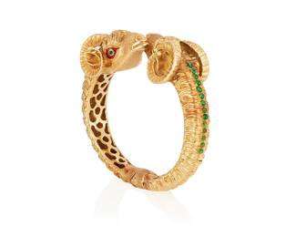 37
An Enamel And Gold Bracelet
The hinged bracelet designed with two ram's head terminals, highlighted with green and red enamel eyes and green glass cabochons, in 18K gold.
61.40 grams
2" Dia.
Estimate: $1,200 - $1,800