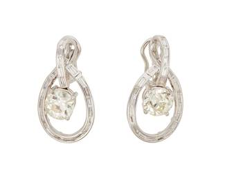 87
A Pair Of Diamond Hoop Earclips
Set with 2 round brilliant-cut diamonds weighing a total of 3.96 carats, and 46 baguette-cut diamonds weighing 1.19 carats, set in 18K white gold.
2 pieces
10.2 grams
1" L x 3/5" W
Estimate: $12,000 - $15,000