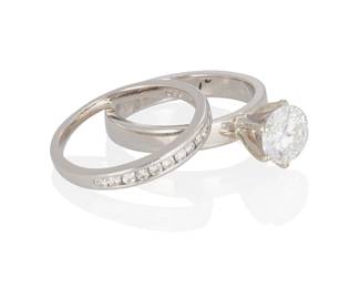 44
A Diamond Wedding Set
The wedding set comprises a round brilliant-cut diamond weighing 1.04 carats, along with a wedding band set with 12 channel-set diamonds totaling approximately .15 carat set in platinum.

Accompanied with a GIA report dated December 27, 2022 stating E color and SI2 clarity.
7.7 grams
2 pieces
Estimate: $2,000 - $3,000
