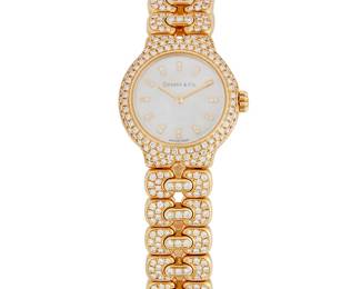 177
A Diamond And Gold 'Tesoro' Wristwatch, Tiffany & Co.
Ref: L0133
Dial: Mother-of-pearl with single-cut diamond markers and baton hands
Movement: Quartz
Case: 25 mm, 18K gold circular case number 59-039
Bracelet: 18K gold Signature Tesoro link bracelet set with numerous round brilliant-cut diamonds, estimated 2.50 carats total weight with deployant clasp, 6.5" L
76.3 grams
Estimate: $6,000 - $8,000