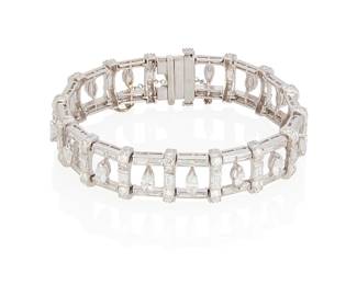 48
A Diamond And Platinum Bracelet
The bracelet features 16 marquise-shaped diamonds weighing approximately 2.32 carats, 80 baguette-cut diamonds weighing approximately 3.04 carats, and 96 round brilliant-cut diamonds weighing approximately 1.92 carats in platinum. Total diamond weight is approximately 7.6 carats.
48.80 grams
7" L x 1/2" W
Estimate: $6,000 - $8,000