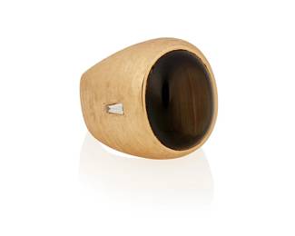 148
A Black Star Sapphire Ring
Designed with an oval-shaped cabochon black star sapphire measuring approximately 18.84 x 15.71 x 7.74 mm and weighing approximately 23.82 carats, highlighted by a tapered baguette-shaped diamond on either side, set in 14K gold.
47.6 grams
Size: 8.25
Estimate: $1,200 - $1,800