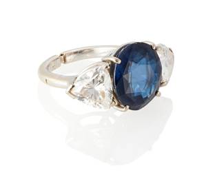 164
A Sapphire And Simulated Diamond Ring
Centering a circular-cut sapphire measuring approximately 12.81 x 11.72 x 6.16 mm and weighing approximately 13.50 carats, flanked on either side by two triangular-cut simulated diamonds measuring approximately 8.2 x 8.8 x 4.65 mm and 8.22 x 8.5 x 4.64 mm.
6.7 grams
Ring size: 5.25
Estimate: $10,000 - $15,000
