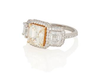 30
A Three Stone Diamond Ring
Centering a square emerald-cut diamond weighing 2.00 carats, flanked by 2 emerald-cut diamonds weighing 1.00 and 1.01 carats, highlighted by round brilliant-cut diamond borders and shank, set in platinum and 18K gold.

Accompanied by GIA report numbers 14855576 and 15278318, stating that the emerald-cut diamonds weighing 1.00 and 1.01 carats are F color, SI1 clarity.
9.8 grams
Size: 7.25
Estimate: $15,000 - $20,000