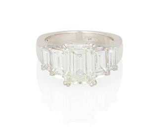 69
A Diamond Ring
Centering an emerald-cut diamond, measuring, 9.96 x 7.42 x 4.80 mm, and weighing 3.34 carats, set between 4 emerald-cut diamonds weighing approximately, 2.26 carats, mounted in platinum.

Accompanied by GIA report number 6234081292 stating that the emerald-cut diamond is J color, SI1 clarity.
11.3 grams
Ring Size: 6.5
Estimate: $15,000 - $20,000