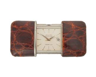 114
Ermeto Purse Watch, Movado For Tiffany & Co.
Ref: 1265 002-M
Dial: White with baton markers and dart hands, date aperture at 3 o'clock, signed Ermetoscope Tiffany & Co.
Movement: Jeweled mechanical Swiss movement (movement not examined)
Case: Case opens and closes to wind movement, steel case with shagreen cover
79 grams
Open: 36 mm x 75 mm x 11 mm; Closed: 36 mm x 50 mm x 11 mm
Estimate: $400 - $600