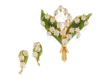 76
A Carved Rock Crystal, Diamond. And Nephrite Set Of Jewelry, Hugler
The set comprising a brooch designed as a bouquet of lily-of-the-valley flowers featuring carved rock crystal lilies highlighted with diamond set stamens, carved nephrite leaves and gold stems, tied together with a diamond set gold ribbon, along with a matching pair of earrings, in 18K gold, signed Hugler.
3 pieces
48.54 grams
Brooch: 47.10 grams; 3 1/4" x 3 inches"; Earrings: 1.44 grams; 1 1/2" x 1/2"
Estimate: $2,000 - $3,000