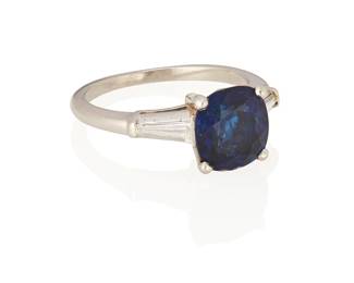 46
A Sapphire And Diamond Ring
Centering a cushion-shaped sapphire weighing 2.89 carats, flanked by two tapered baguette-cut diamonds weighing approximately .30 carat, set in platinum.

Accompanied by Gubelin report number 20092017 stating that the sapphire is of Burmese origin, with no indications of heat treatment.
4.40 grams
Size: 5.5
Estimate: $8,000 - $12,000