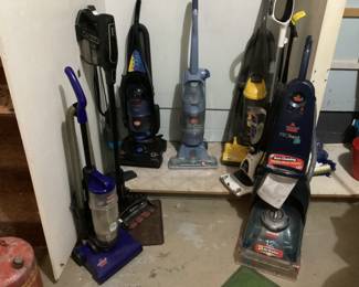 A collection of vacuums / floor cleaners. Hoover, Bissell, Shark