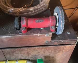 vintage Wood Wizard belt driven grinder mounted on a grinding station that also has a motor mounted wire wheel. The motor driving this arbor is inside the homemade  case