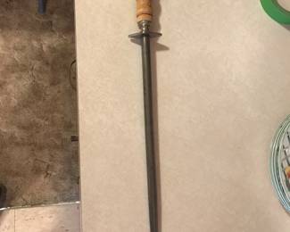 This knife steel is part of a set used in the kitchen at the Little Rock Air Force base that includes two Dexter nylon handled knives, all worn but functional! The steel measures 20", including the handle. 