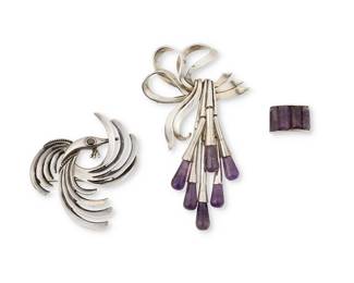 2177
A Group Of Antonio Pineda Mexican Silver And Amethyst Jewelry
Antonio Pineda (1919-2009)
Circa 1953-1979; Taxco, Mexico
Each with crown mark for Antonio Pineda / Eagle 17; further variously stamped: Hecho en Mexico / Silver / 970 / Sterling / Made in Mexico / [Design number]
Three works comprising a sterling silver bow brooch suspending trumpet-style silver drops tipped with amethyst (No. PR527; 4.25" H x 2.375" W), a stylized bird brooch with clear set stone eye (2.5" H x 2.5" W), as well as an amethyst bar-set sterling silver ring (ring size: 4.75), 3 pieces
101.0 grams gross
Estimate: $600 - $800
