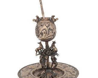 2067
19th Century
A Latin American Silver Yerba Mate Tea Vessel
Appears unmarked
The silver tea set with chased and repoussé sylvan designs, scrolled acanthus, and mask motifs to cup and footed tazza raised on hoof feet, the stem decorated with griffins and foxes, the cup with applied squirrels and a conformingly designed straw/spoon, 2 pieces
Stand: 10" H x 9" Dia.; straw: 8" L
33.9 oz. troy approximately
Estimate: $600 - $800