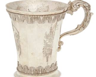 2066
19th century or earlier; South American
A Spanish Colonial Silver Mug
Possibly monogrammed to two sides: B
The sixteen-sided mug with cast scrolled handle, applied and chased rim and base trim, and incised floral motifs
5.125" H x 5.875" W x 4.125" Dia.
16 oz. troy approximately
Estimate: $400 - $600