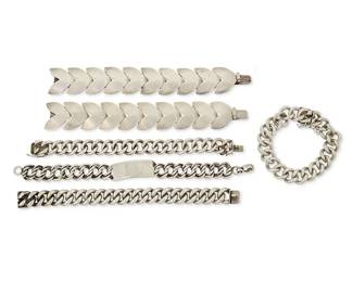 2131
A Group Of Fred Davis Mexican Silver Bracelets
Frederick W Davis (1880-1961)
Pre-1948; Mexico City, Mexico
Each stamped: FD for Fred Davis; further stamped: 925 / Silver / Made in Mexico / Mexico
Six works comprising two sterling silver chevron link bracelets (each: 7.5" L x 1.125" H), three chunky sterling silver cable link bracelets (Largest: 8" L; Smallest: 7.5" L), and a sterling silver ID bracelet with double chain links (8.75" L x 0.625" H), 6 pieces
411.0 grams
Estimate: $800 - $1,200