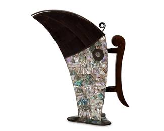 2080
Mid-20th century
A Mexican Abalone Inlaid Toucan Pitcher
Stamped to underside: Hecho en Mexico
The silver-toned metal pitcher inlaid with abalone and wood with a hinged lid and carved wood handle
12" H x 10.625" W x 5" D
Estimate: $300 - $500