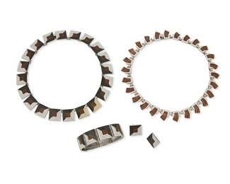 2191
A Group Of Margo De Taxco Silver And Enamel Jewelry
Margot Van Voorhies (1896-1985)
Circa 1955-1978; Taxco, Mexico
Each stamped: Margot de Taxco / Sterling / Made in Mexico / [Eagle 16] / [Design number]
Four works designed by Margot Van Voorhies comprising a sterling silver and brown, white, and black enamel "Shadow Box" square link necklace (No. 5461; 14.75" L x 0.625" H), together with a matching bracelet (6.5" L x 0.625" H) and a pair of matching earrings (each: 0.625" H), as well as a white and brown enamel "Flanges in Square" link necklace (No. 5633; 15.5" H x 0.625" H), 5 pieces
194.5 grams gross
Estimate: $700 - $900