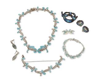 2194
A Group Of Margot De Taxco Sterling Silver And Enamel Jewelry
Margot Van Voorhies (1896-1985)
Circa 1955-1978; Taxco, Mexico
Each stamped: Margot de Taxco / Sterling / Made in Mexico / [Eagle 16] / [Design number]
Designed by Margot Van Voorhies, comprising a "Leaf and Scroll" silver and blue enamel link necklace (No. 5389; 17" L) and matching link bracelet (7" L), a "Folk Art Doves" bird silver and blue enamel link bracelet (No. 5868; 7.75" L) with matching pin (0.625" H x 1.75" W), a "Circle tied Bow" ribbon motif brooch in silver and blue mosaic enamel (No. 5689; 1.5" H x 2.375" W) with a matching pair of earclips (each: 1" H), and a pair of "Fanciful Pendants" silver and blue enamel earclips (No. 5701: each: 1.375" H), 9 pieces
204.2 grams gross
Estimate: $800 - $1,200