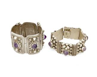 2230
Two Mexican Silver And Amethyst Bracelets
Mid-20th century
Variously marked: JC [conjoined] / Taxco / 980; [partial] Hecho___ / Guadal / Alpaca
Comprising a five-link sterling bracelet with applied geometric motifs, each link with a central set amethyst (6" L x 1.75" H), together with a six-link silver and amethyst bracelet with stacked ball motif (7.375" L x 1" H), 2 pieces
187.5 grams gross
Estimate: $300 - $500