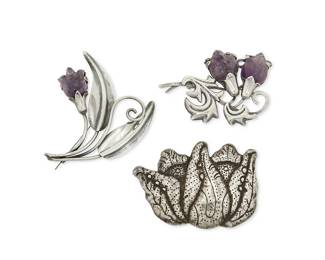 2132
A Group Of Fred Davis Mexican Silver And Amethyst Brooches
Frederick W Davis (1880-1961)
Pre-1948; Mexico City, Mexico
Each stamped: FD; further stamped: Silver / Made in Mexico / Sterling
Comprising two stylized flower motif brooches set with carved amethyst flowers (Larger: 3" H x 3.5" W; Smaller: 2.5" H x 3.25" W), and a stylized floral and foliate repoussé silver brooch (2.5" H x 3.5" W), 3 pieces
87.0 grams gross
Estimate: $700 - $900