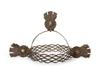 2059
19th century
A Silver-Metal Crown Of Thorns
Appears unmarked
Comprised of an openwork barbed circlet, with three repoussé spiked medallions attached to a repoussé silver-metal band, likely a santos ornament
7" H x 12" W x 6.5" Dia. approximately
Estimate: $600 - $800