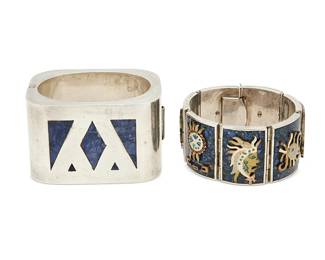 2229
Two Mexican Silver Bracelets
Mid-20th century
One stamped: Metales / Taxco / Mexico / TD-34 / 925
Comprising a large chunky hinged silver cuff bangle with geometric lapis stone inlay (6.5" inner C x 1.75" H) and a sterling silver hinged bracelet with chipped lapis panels and applied mixed metal figurative and abstract motifs (6.75" L x 1.25" H), 2 pieces
316.1 grams gross
Estimate: $300 - $500