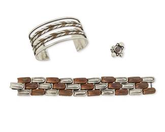 2137
A Group Of William Spratling Silver, Copper And Amethyst Jewelry
William Spratling (1900-1967)
Circa 1933-1938 and 1940-1946, First Design Period; Taxco, Mexico
Each stamped for William Spratling; further stamped: Made in Mexico / Silver / Taxco / 980
Three works including a four-wire cuff bracelet with silver and copper herringbone accents and stamped terminals (7.25" total inner C x 1.25" H, with a 1.5" gap), a silver and copper link bracelet (7" L x 1" H) and a silver ring with set amethyst and silver ball accents (ring size: 6), 3 pieces
174.2 grams gross
Estimate: $1,000 - $1,500