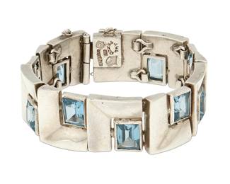 2153
An Antonio Pineda Mexican Silver And Aquamarine Bracelet
Antonio Pineda (1919-2009)
Circa 1953-1979; Taxco, Mexico
Crown mark for Antonio Pineda; further stamped: 970 / Taxco / JVL Taxco / Sterling / [indistinct eagle]
Comprising a link bracelet, with each square link featuring a set faceted aquamarine to one corner
6.75" L x 0.75" H
112.8 grams gross
Estimate: $700 - $900