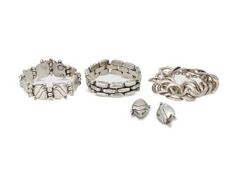 2139
A Group Of William Spratling Mexican Silver Jewelry
William Spratling (1900-1967)
Circa 1940-1946, First Design Period; Taxco, Mexico
Each stamped for William Spratling; further variously stamped: Made in Mexico / Silver
Four works including a sculpted oval silver chain link bracelet (7.5" L x 1" H), a three-row silver brick link bracelet (7.5" L x 0.75" H), and an abstract silver "cushion" and ball link bracelet (7.25" L x 1" H) with a pair of matching screw back earrings (each: 1" H), 5 pieces
271.9 grams
Estimate: $800 - $1,200