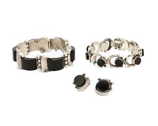2167
A Group Of Antonio Pineda Mexican Silver And Onyx Jewelry
Antonio Pineda (1919-2009)
Circa 1953-1979; Taxco, Mexico
Each with crown mark for Antonio Pineda; Eagle 3; Eagle 17; further variously stamped: Taxco / Mexico / JCG / Hecho en Mexico / 970; one earring stamped: Mota Tasco
Three works comprising a sterling silver and curved set onyx link bracelet (7.25" L x 0.875" H) as well as a sterling silver and horse-bit motif link bracelet with set round onyx (7.375" L x 0.75" H) and a pair of matching earclips (each: 0.875" H), 4 pieces
156.2 grams gross
Estimate: $1,000 - $2,000