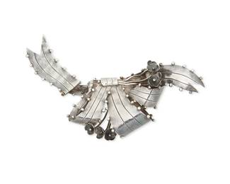 2224
A William Spratling Silver Bow Brooch
William Spratling (1900-1967)
Circa 1940-1944, First Design Period; Taxco, Mexico
Stamped for William Spratling; further stamped: Made in Mexico / Sterling
Comprising a large ribbon motif "Wavy Bow" brooch with floral accents
4" H x 6.25" W
66.9 grams gross
Estimate: $500 - $700