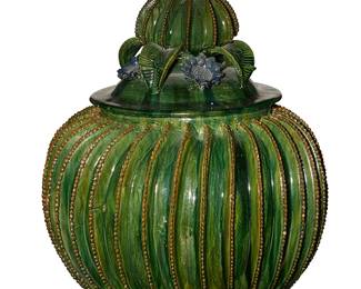 2098
Late 20th century; Michoacán, Mexico
A Hilario Alejos Madrigal Pottery Biznaga Pot
Appears unsigned
The green glazed ceramic pot of barrel cactus form raised by three feet and surmounted by a cactus finial lid centered by flowers
22" H x 16.75" Dia.
Estimate: $400 - $600
