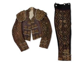 2063
An Embellished "Traje De Luces" Matador Set
Early/mid-20th century
The "suit of light" chaquetilla jacket and pants in brown and black fabric embroidered with sequins and reflective metal thread, with bullion fringe and beaded embellishments, 2 pieces
Jacket: 16.75" H (center back); 17" W (inner shoulders); sleeves: 23" L approximately; trousers: 14" W (waist); 33" H (side leg); inseam: 18" H
Estimate: $500 - $800
