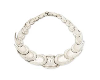 2163
An Antonio Pineda Mexican Silver Necklace
Antonio Pineda (1919-2009)
Circa 1953-1979; Taxco, Mexico
Crown mark for Antonio Pineda; Eagle 17; further stamped: Made in Mexico / Silver / [Partial] YY44_[D?]
A collar necklace comprising of graduating raised edge wave links
14" L x 1.25" H
144.1 grams
Estimate: $800 - $1,200