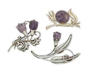 2123
A Group Of Fred Davis Mexican Silver And Amethyst Brooches
Frederick W Davis (1880-1961)
Circa pre-1948; Mexico City, Mexico
Each stamped: FD: further stamped: Silver / Made in Mexico
A group comprising two stylized silver and carved amethyst floral sprig brooches (larger: 3" H x 4.25" W; smaller: 2.75" H x 3.75" W), as well as a vermeil silver floral sprig brooch set with a large amethyst cabochon (2.125" H x 3" W), 3 pieces
107.7 grams gross
Estimate: $800 - $1,200