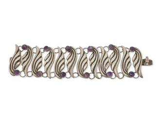 2120
A Fred Davis Silver And Amethyst Bracelet
Frederick W Davis (1880-1961)
Pre-1948; Mexico City, Mexico
Stamped: FD for Fred Davis; further stamped: Made in Mexico / Silver
Designed as a stylized wing link bracelet tipped with amethyst cabochons
7.25" L x 1.875" H
86.5 grams gross
Estimate: $400 - $600
