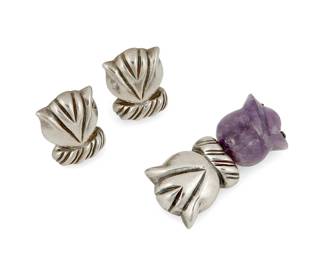 2140
A Set Of William Spratling Silver And Amethyst Jewelry
William Spratling (1900-1967)
Circa 1944-1946, First Design Period; Taxco, Mexico
Each stamped for William Spratling; Further stamped: Made in Mexico / Spratling Silver
Comprising a sterling silver and carved amethyst floral brooch and a pair of matching silver screw back earrings, 3 pieces
Brooch: 2" H x 1" W; Each earring: 1.125" H
36.7 grams gross
Estimate: $300 - $500
