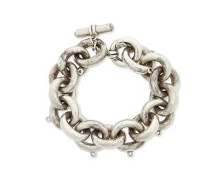 2217
An Antonio Pineda Mexican Silver Chain Bracelet
Antonio Pineda (1919-2009)
Circa 1953-1979; Taxco, Mexico
Crown mark for Antonio Pineda; Eagle 58; further stamped: Hecho en Mexico / 970
Comprising a chunky cable link charm bracelet with set greenstone toggle clasp, lacking charms
9" L x 1" H
108.8 grams gross
Estimate: $300 - $500