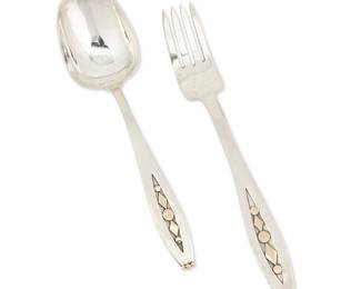 2105
Two William Spratling Silver And Gold Flatware Utensils
William Spratling (1900-1967)
Circa 1965-1967, Third Design Period; Taxco, Mexico
Each stamped for William Spratling; further stamped: [Eagle 63]
Comprising a fork and spoon, each with applied pattern of gold diamonds and dots to front and back, 2 pieces
Each: 7.25" L
4.4 oz. troy approximately
Estimate: $400 - $600